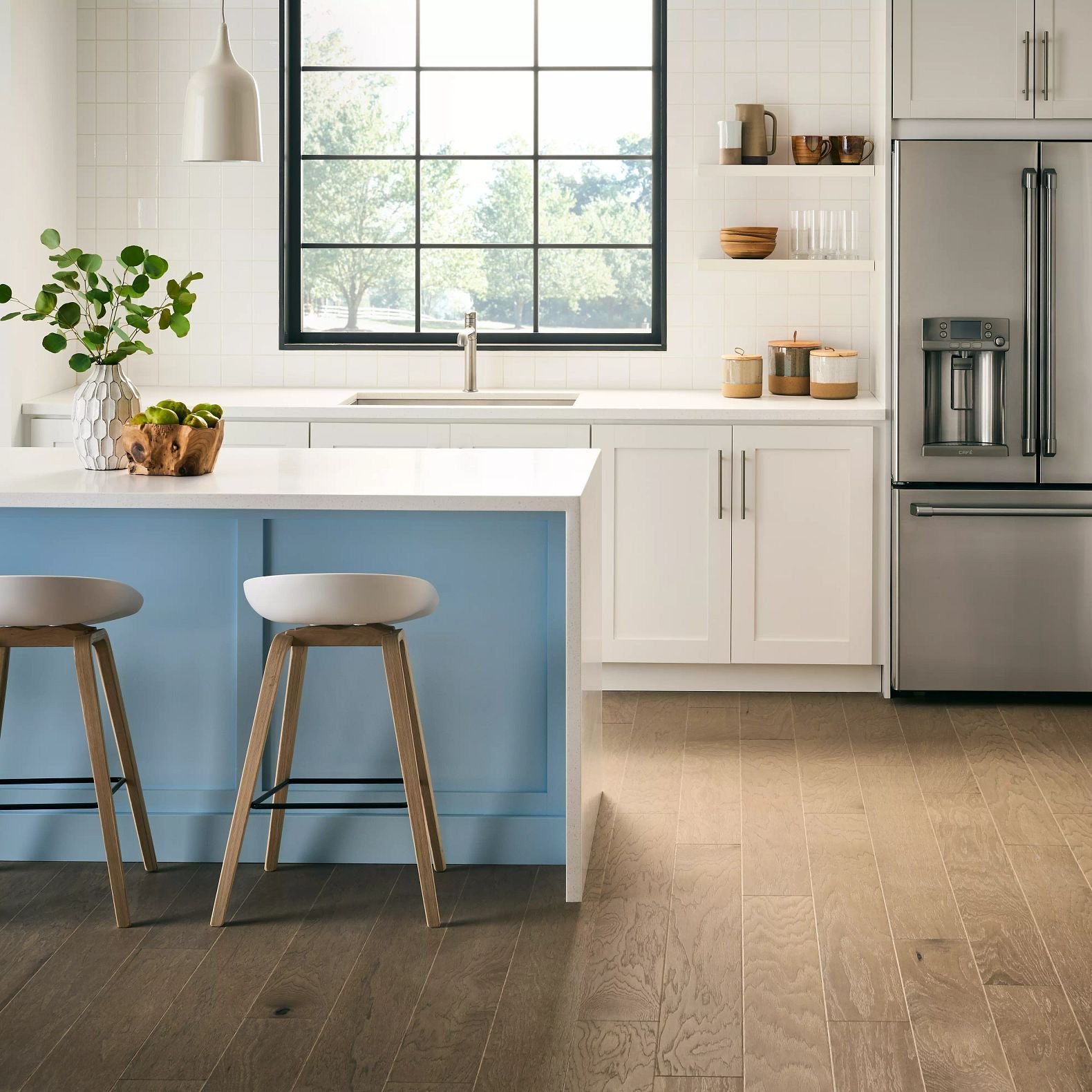 blue island kitchen table with white countertop and a brown hardwood floor from Floor Store and Design in Columbia, TN